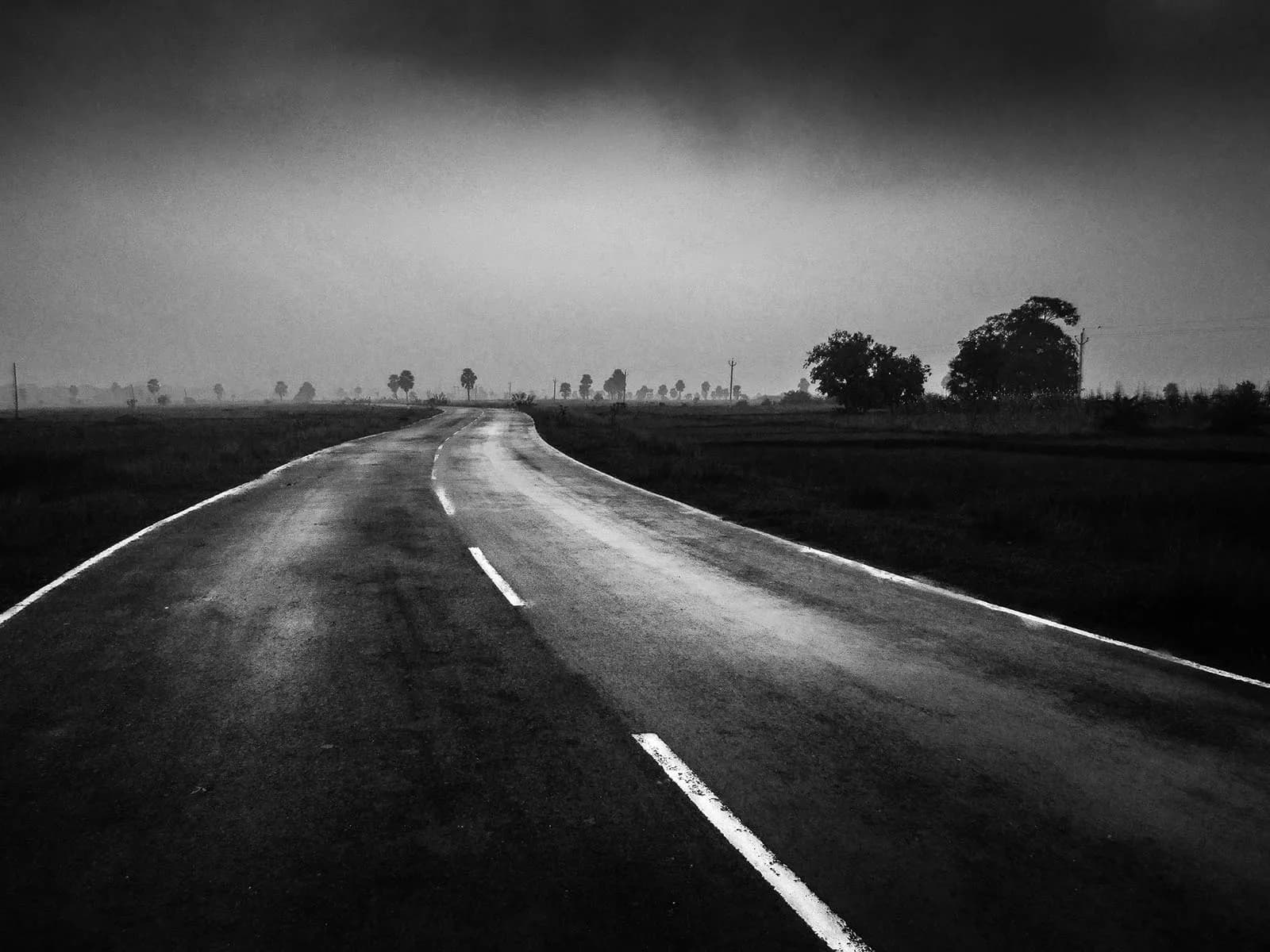 Winding empty road after rain